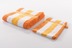 In terrakotta/orange: Gözze Frottierserie New York Streifen orange/weiß/gelb